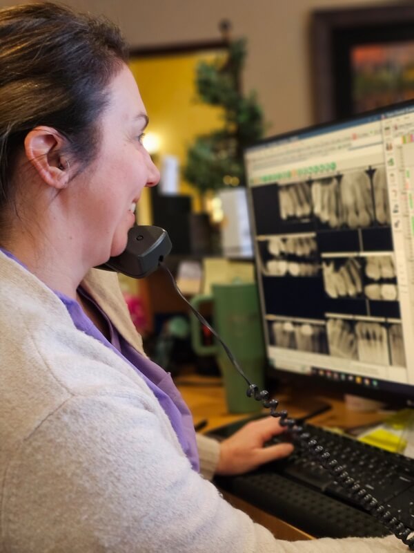 Dental Assistant Reviewing Dental X-Rays