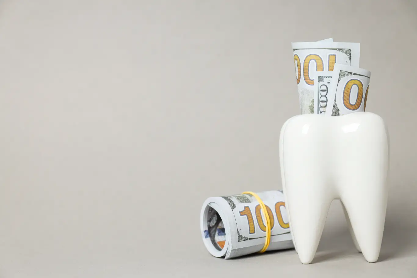 A decorative tooth with rolls of dollars